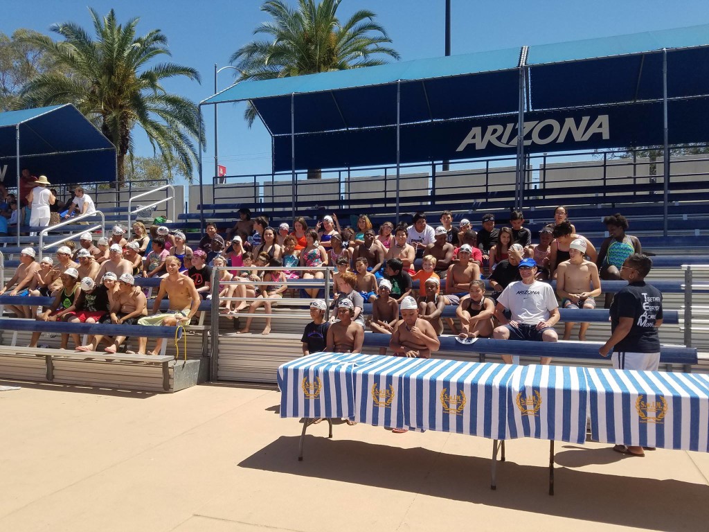 Participants, teachers and Olympian Ben Kanute poses for photographs before the swim lesson. Photo courtesy Primavera Foundation